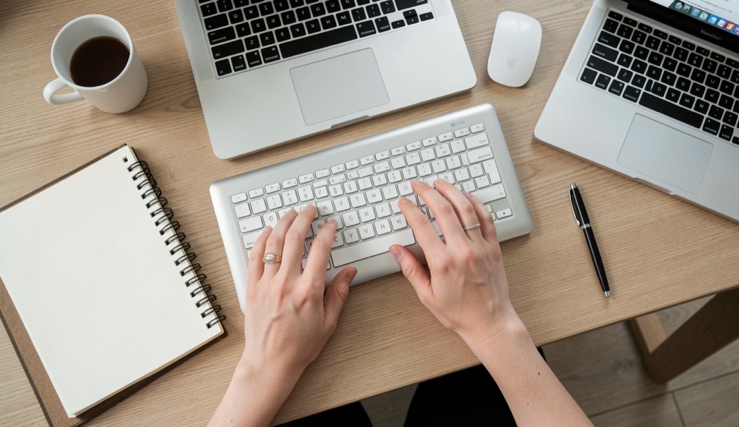 Jabber and XMPP: a protocol you can read: A laptop on a wooden desk at dusk, its screen showing a plain text log of XML stream tags, a notebook and pen beside it, warm lamp light from the left